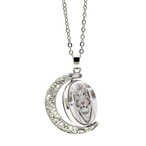 Detailed macro view of rotating white tiger glass moon pendant with hollowed silver chain