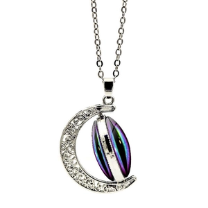 Detail of moon pendant with vintage patterns and colorful aurora starstone on silver chain