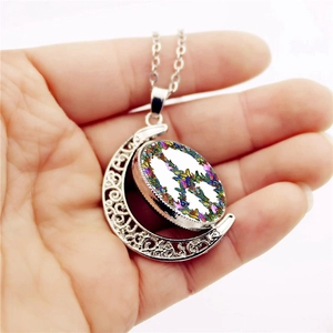 Rotating moon pendant necklace with peace sign butterfly pattern in silver finish