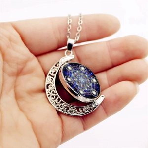 Rotating moon pendant necklace with Metatron's Cube sacred geometry on starry background
