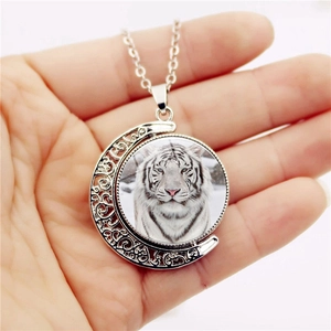 Rotating moon pendant necklace with white tiger glass gem in silver hollow frame
