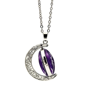 Close-up of vintage hollow moon pendant with a rotating purple galaxy stone on silver chain