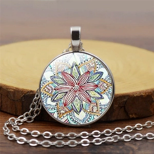 Colorful mandala glass dome pendant necklace with silver chain on rustic wood background