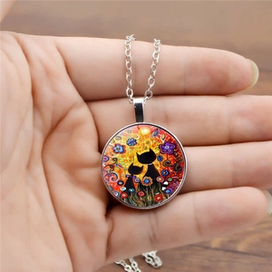 Artistic cat time gem pendant necklace featuring two black cats in a floral garden design