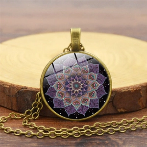 Dettaglio ravvicinato della collana mandala in bronzo antico su uno sfondo di legno rustico