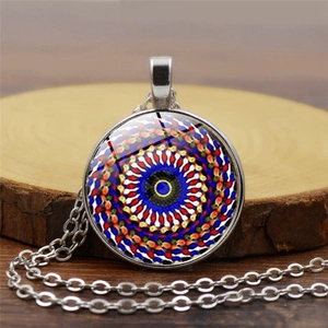 Mandala glass cabochon pendant necklace with colorful patterns on a wooden background