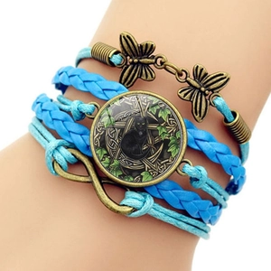 Detail of Wicca black cat glass gem bracelet with infinity symbol and butterfly charms