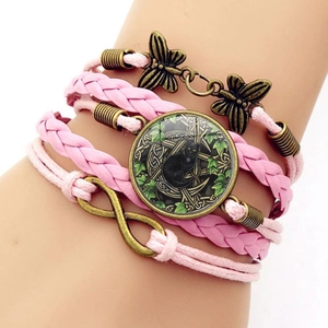 Detail view of Wicca black cat glass gem and bronze butterfly on pink braided bracelet