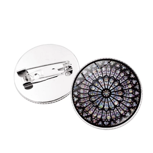 Front and back detail of a round brooch featuring Notre Dame rose window art glass pattern