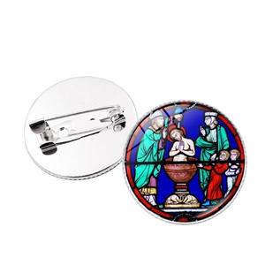 Detail of cathedral stained glass brooch showing colorful front and silver metal pin back