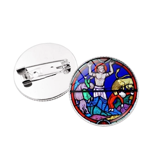 Detail view of round rose window brooch with colorful stained glass art and pin clasp