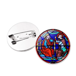 Detailed view of Notre Dame rose window brooch with medieval art and silver pin back