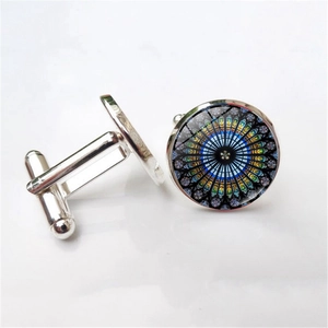 Silver cufflinks with colorful Notre Dame rose window pattern on a white background