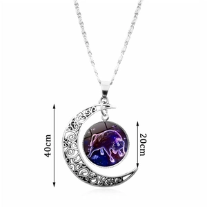 Silver crescent moon necklace with Taurus zodiac glass gem pendant on white background