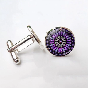 Macro view of silver cufflinks with purple Gothic Rose Window glass design details