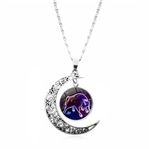 Detail of silver moon crescent pendant with Taurus constellation glass cabochon