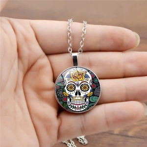 Mexican sugar skull necklace with colorful floral pendant on silver link chain