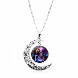 Close-up of silver crescent moon pendant with purple star gemstone and goddess design
