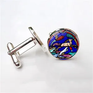 Detailed close-up of Notre Dame rose window cufflinks with hunting scene art
