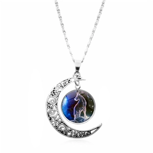 Detailed macro view of silver hollow moon pendant with Capricorn zodiac glass gemstone