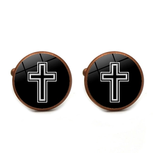 Detail of vintage bronze cufflinks featuring white cross pattern under glass dome