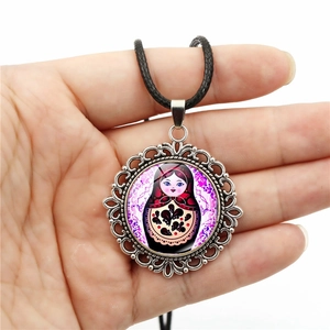 Vintage silver locket necklace with red Russian nesting doll pattern and black cord