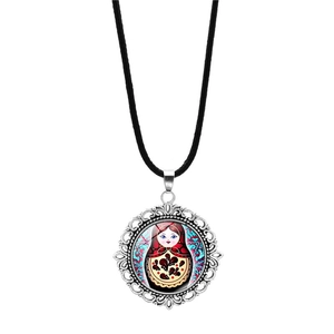 Detailed view of Matryoshka glass dome pendant with silver alloy lace frame on black cord