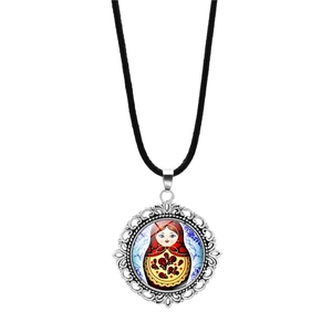 Detailed macro view of Matryoshka doll glass pendant with silver filigree frame