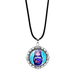 Detailed view of Matryoshka doll pendant with silver hollow patterns on a black cord