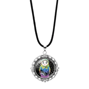 Detailed close-up of a vintage Russian nesting doll pendant on a black cord necklace