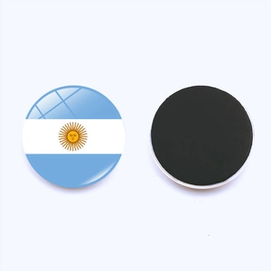 Detail view showing front Argentina flag design and black magnetic back of round fridge magnet
