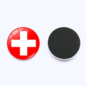 Macro detail of round Switzerland flag magnets showing glossy front and black magnetic back