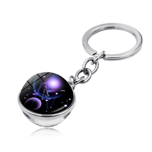 Detail of Libra zodiac glass ball keychain with purple galaxy background and silver ring