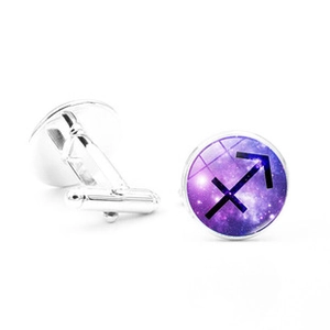 Detailed macro view of silver Sagittarius zodiac cufflinks with purple nebula star glass cabochon