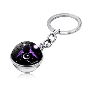 Detailed macro view of Gemini double-sided crystal ball keychain with purple galaxy motif