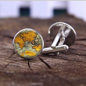Detail view of silver men's cufflinks with vintage world map glass cabochon inserts