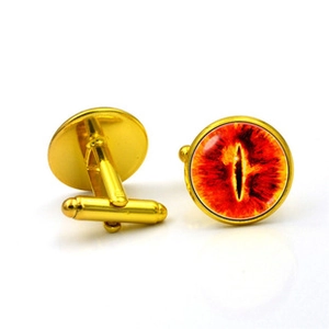 Detailed close-up of gold shirt cufflinks featuring a vibrant red eye glass gem design