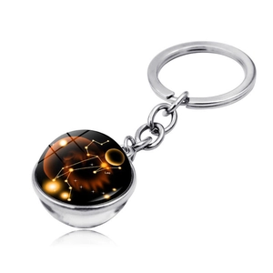 Detail of double-sided glass ball keychain with Leo zodiac constellation design