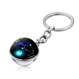 Macro detail of Taurus constellation glass ball pendant on silver stainless steel keychain