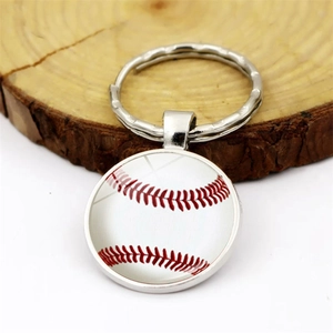 Sports-themed silver keychain with baseball pendant on wooden stand with white background