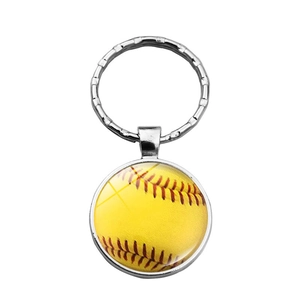 Detailed close-up of a silver sports keychain featuring a realistic yellow softball design