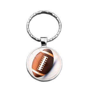 Detailed close-up of American football keychain with glass pendant and silver metal ring