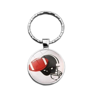 Detail of metal keychain with American football and helmet graphic on glass pendant