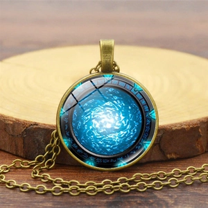 Vintage bronze Stargate Atlantis necklace with blue swirl gem and mystical runes