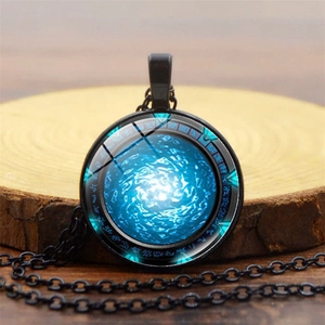 Stargate Atlantis pendant necklace with blue nebula design on rustic wood background