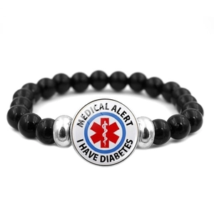 Close-up of medical alert bracelet showing Star of Life and I HAVE DIABETES text