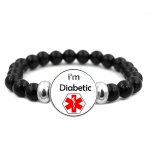 Detail view of medical alert bracelet with black beads and I am Diabetic sign