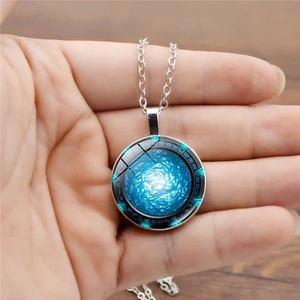 Macro view of Stargate Atlantis glass dome pendant with blue nebula and ancient runes