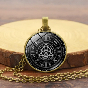 Vintage bronze astrology pendant necklace featuring Celtic triquetra and zodiac symbols