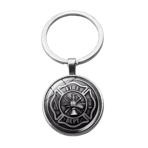 Detail view of Fire Dept badge keychain with silver Maltese cross and firefighter symbols